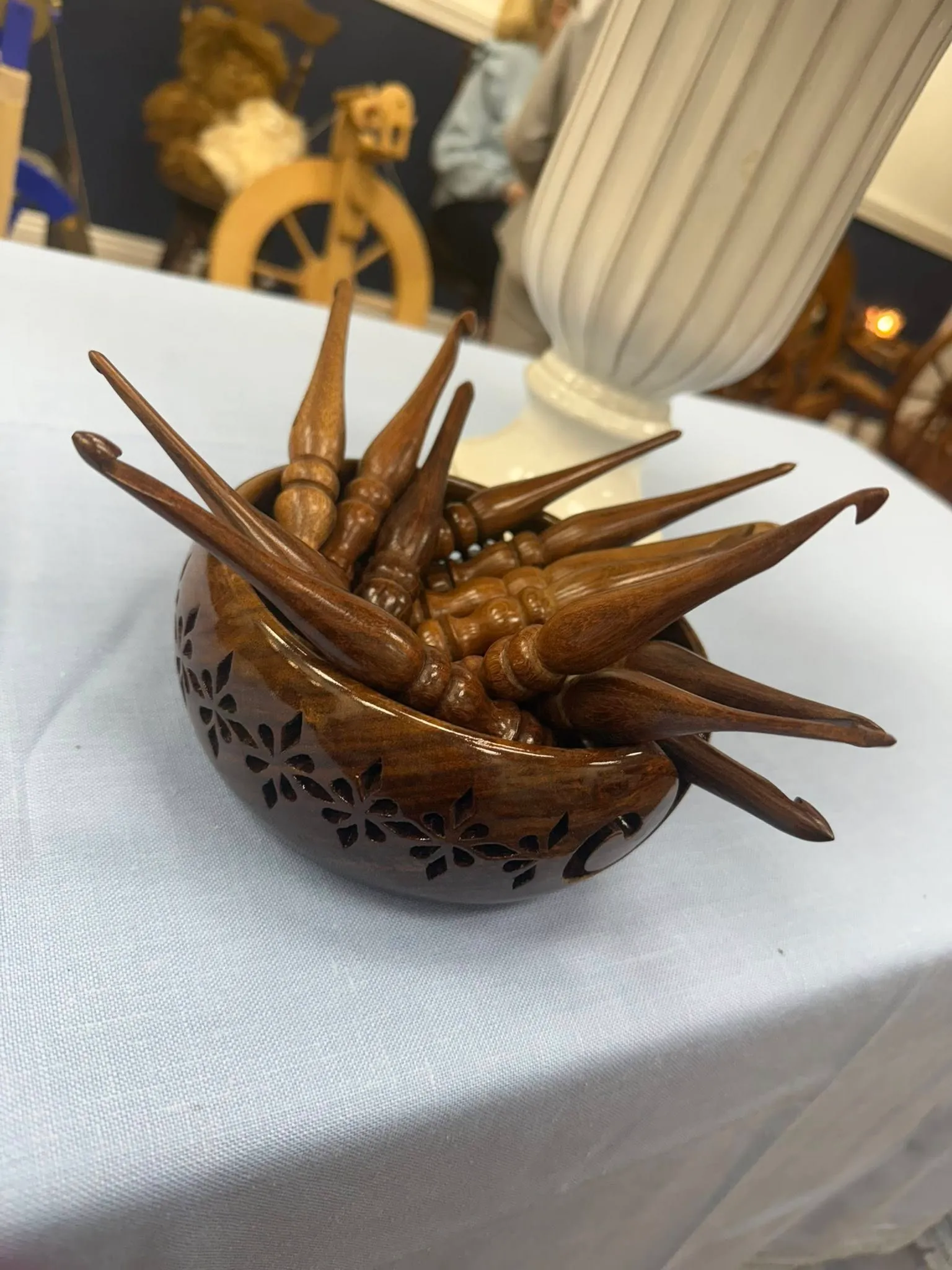 Crochet hooks displayed in a wooden bowl